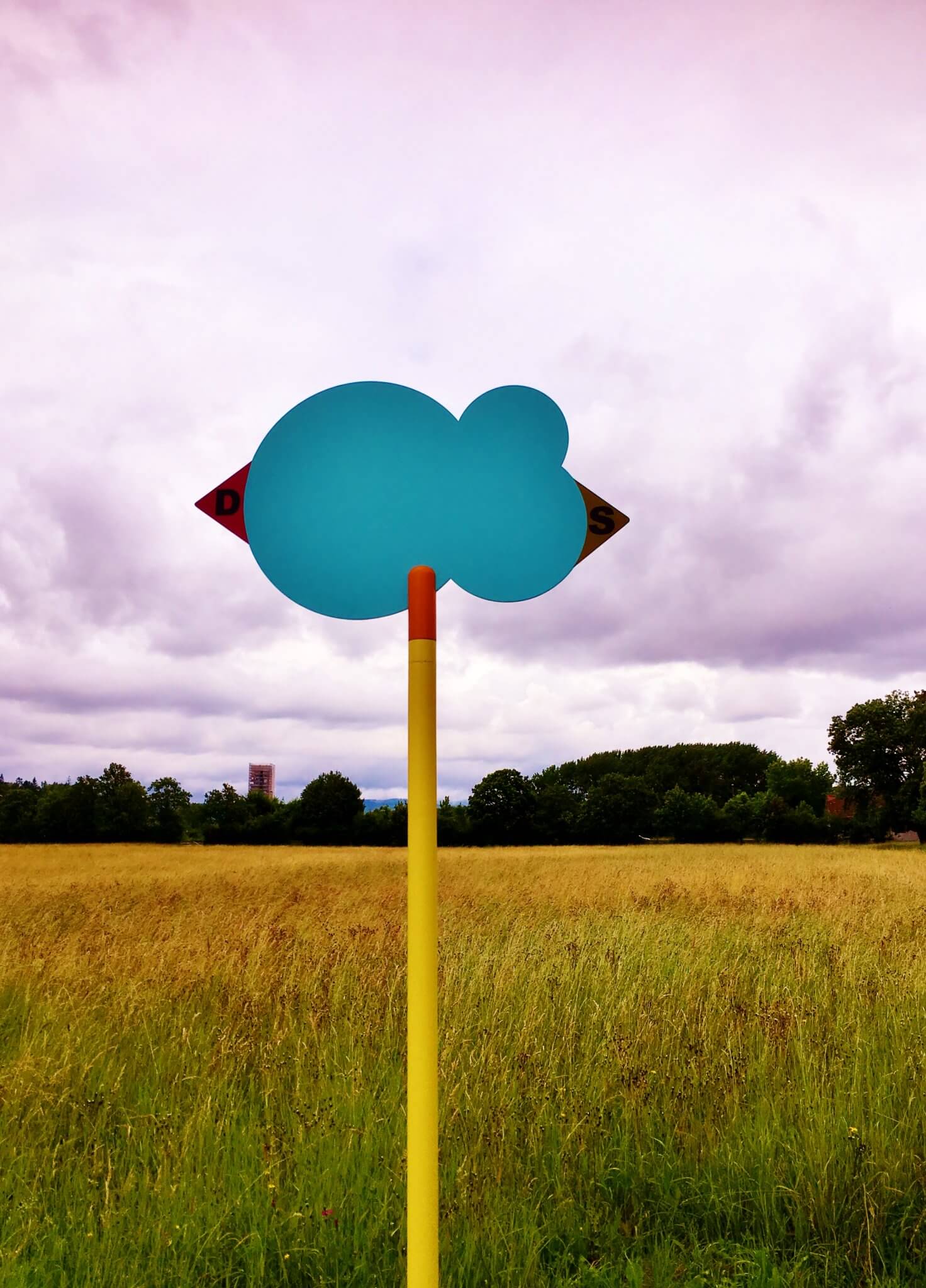 A waymarker showing the direction on the hiking trail between Germany and Switzerland. Check out how art and hiking can be combined- on europediaries.com.